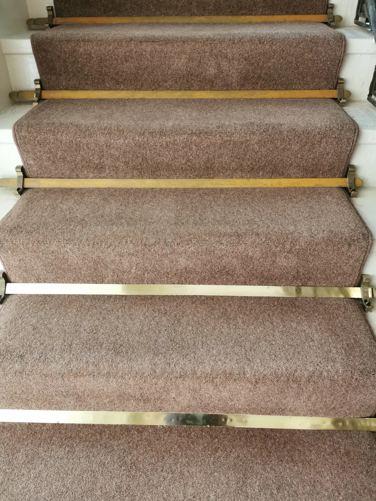 Staircase with polished brass strips