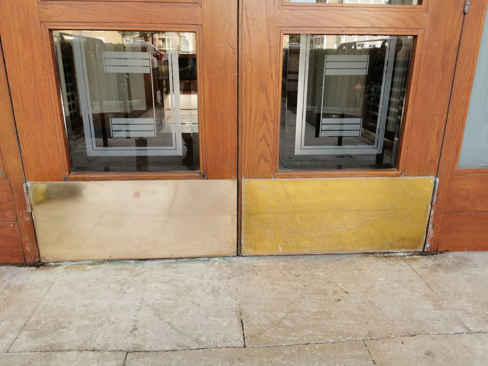 Building entrance with brass protection plates
