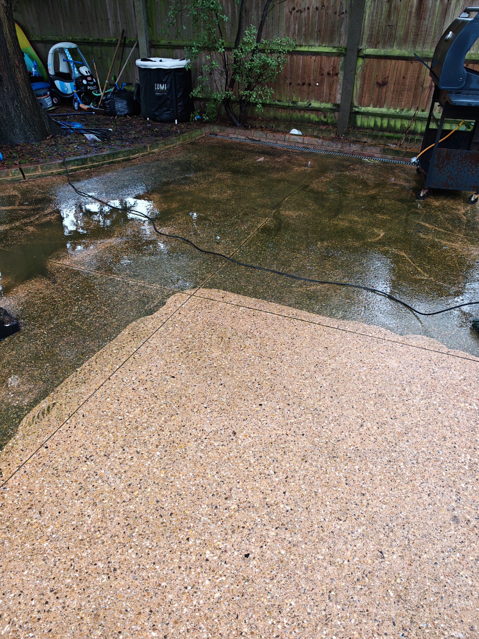 Dark weathered patio before pressure washing
